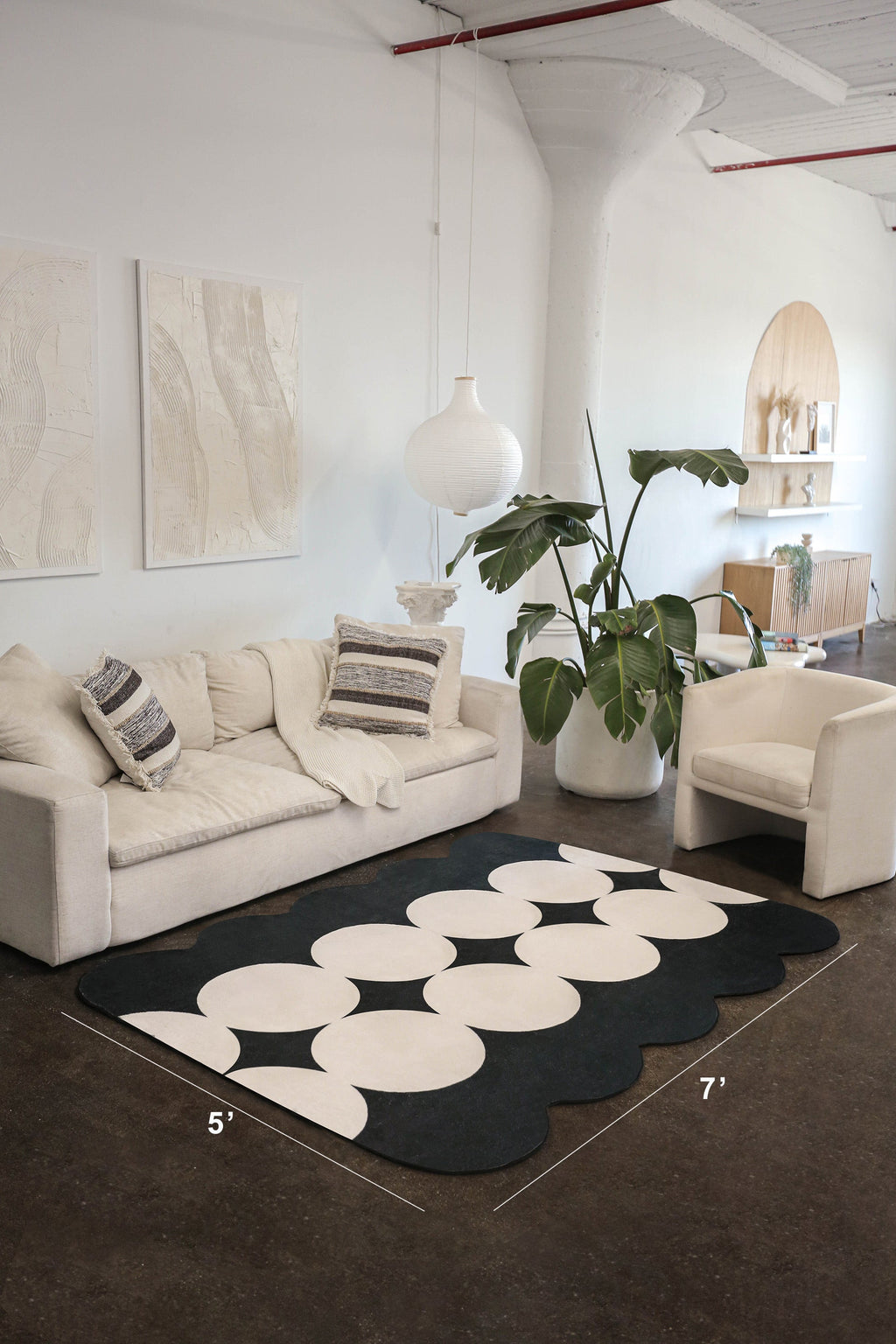 Close-up of the geometric rug in a modern living room, showing its 5' by 7' dimensions.