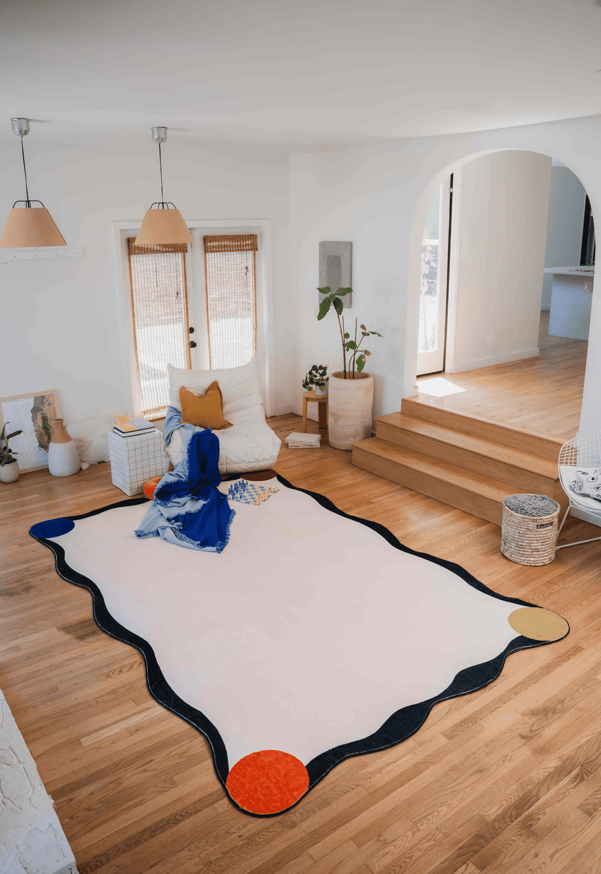 Irregular Novelty Ivory Rug placed in a spacious, sunlit living room with wooden floor and modern minimalist decor.