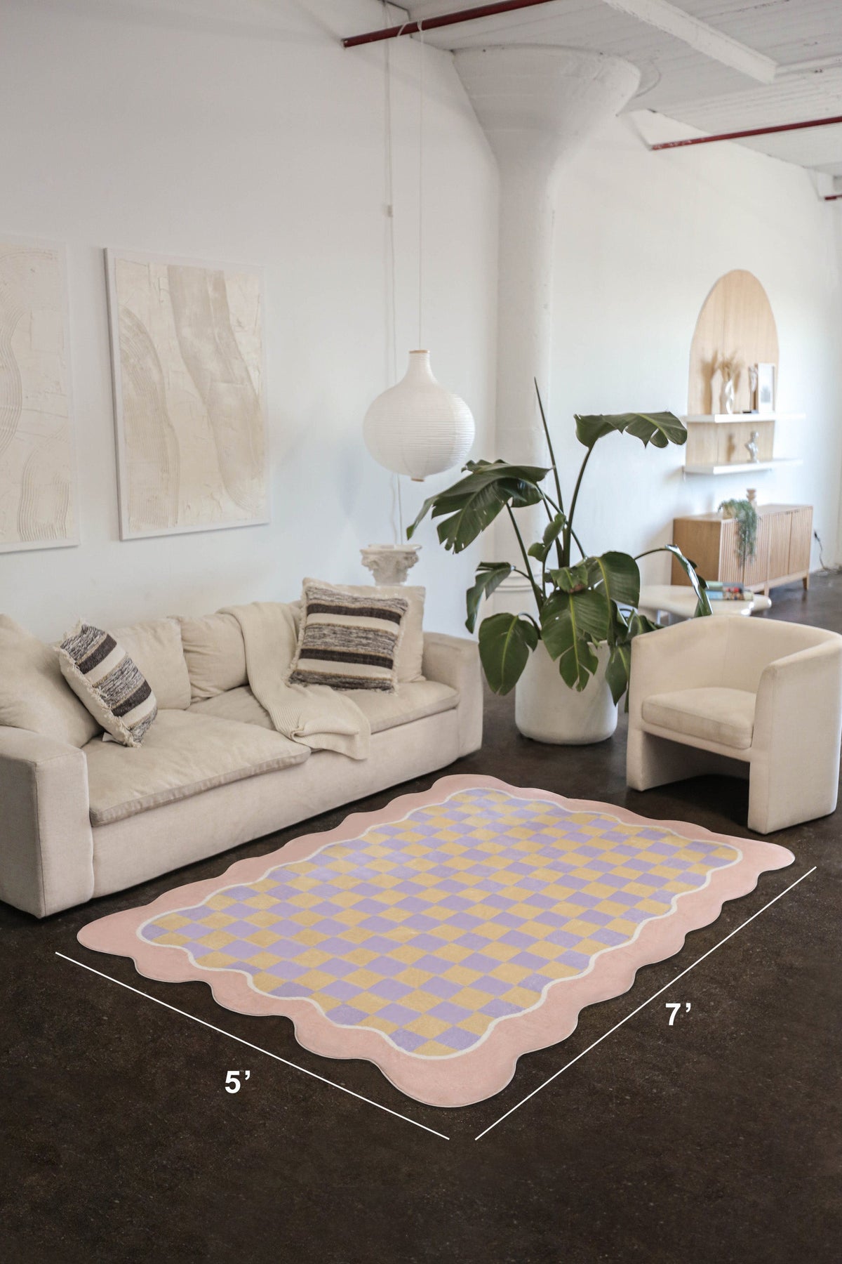 Room view featuring the Mellow Pastel Rug in 5'x7' size, styled beneath a cream sofa and armchair in a modern open space.