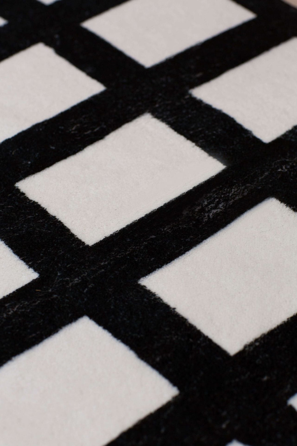 Detailed close-up of the grid runner showing its plush texture and bold geometric pattern.