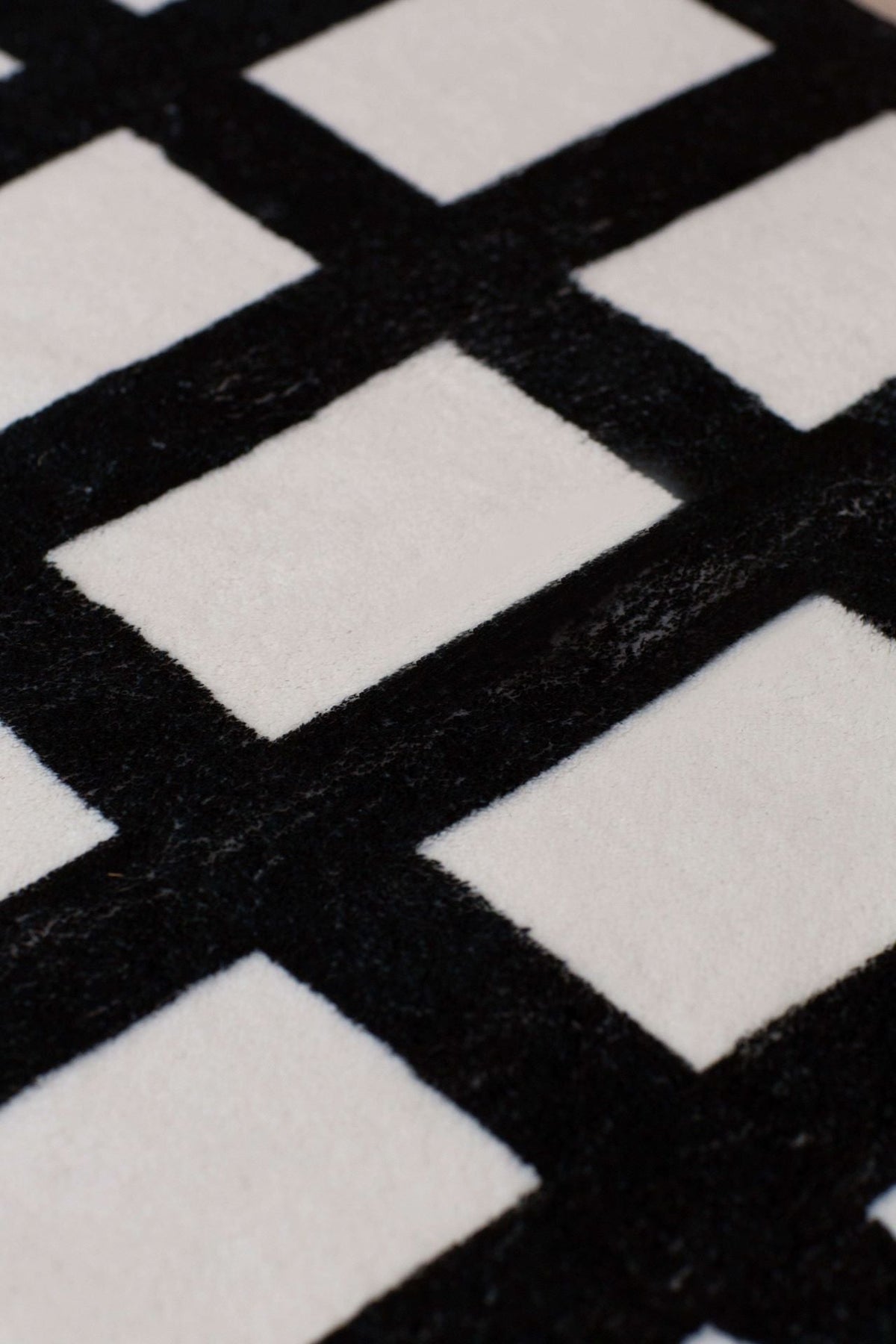 Detailed close-up of the grid runner showing its plush texture and bold geometric pattern.