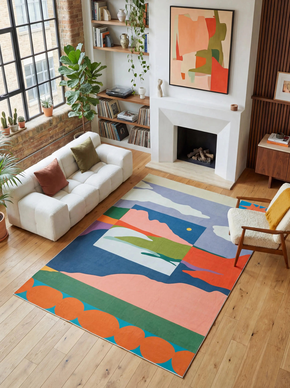 Vintage Landscape Area Rug by Sophie Deller in a bright living room with a white sofa, fireplace, and tall windows