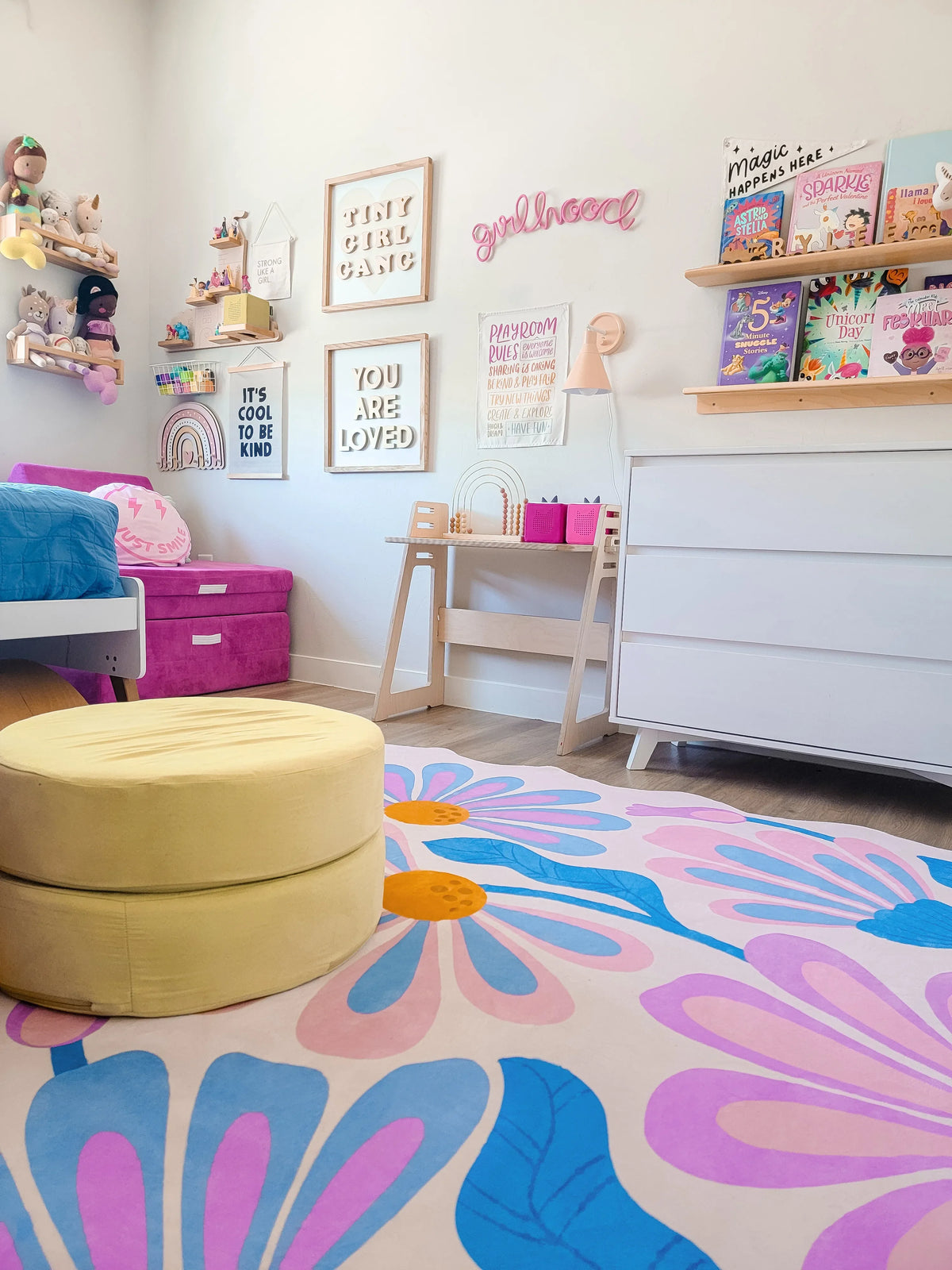 Lilac floral wavy rug in the middle of a playful bedroom, placed on pale wood floor.