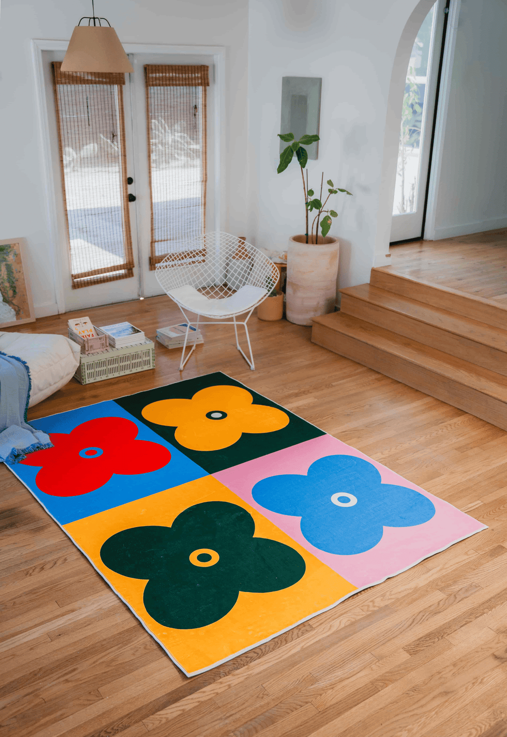 Multicolor Four Leaf Clover Rug placed in a sunlit room with wood floors and modern furniture.