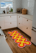 Irregular Coral Design Runner by Johann Banta on wooden floor in a modern kitchen corner with white cabinets and counter decor.