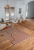 Wide view of the Curvy Brown Stripes Design Rug laid out in a bright living room, framed by modern furniture and arched doorway.