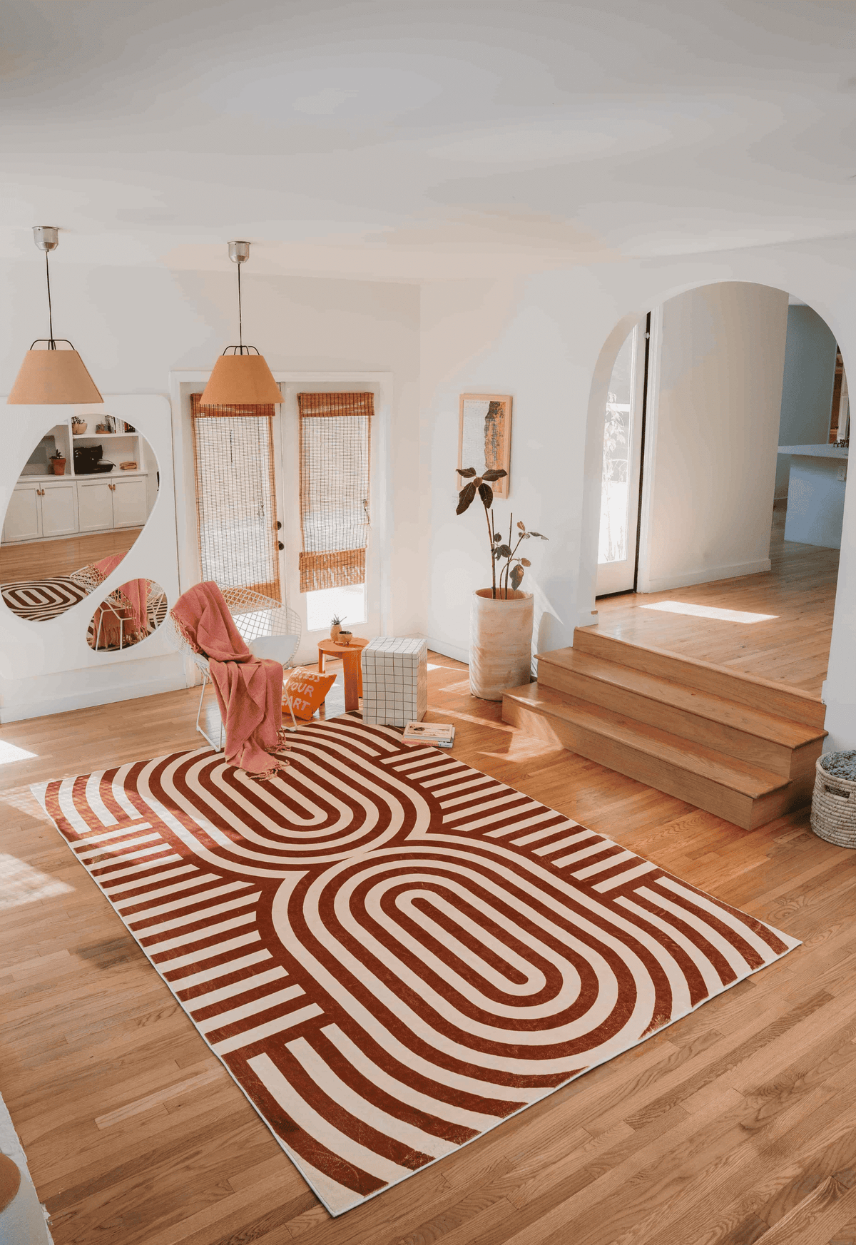 Curvy Brown Stripes Design Rug laid in a sunlit modern living room with arched doorway and layered decor elements.