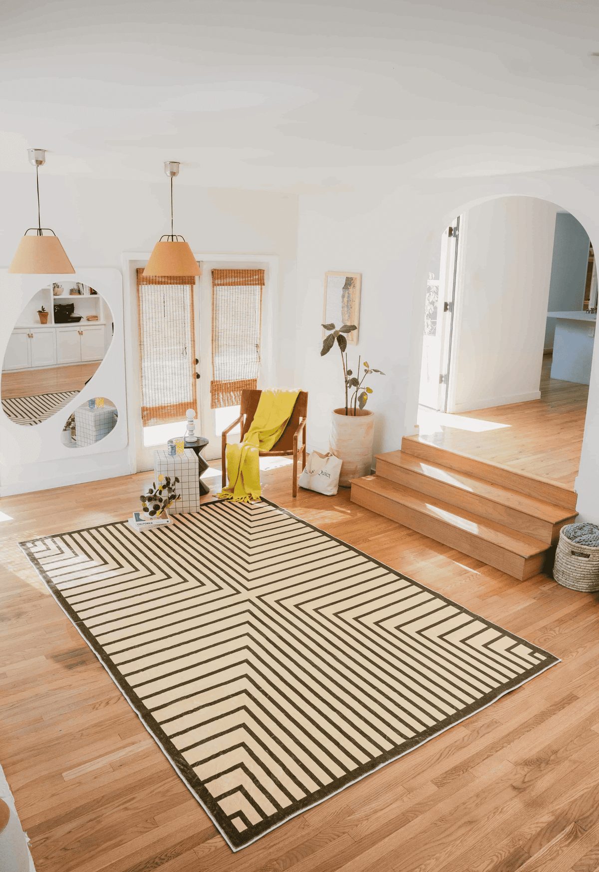 Olive Green Striped Minimalist Rug in sunlit room with wood floor, yellow throw on accent chair, and grid side table.