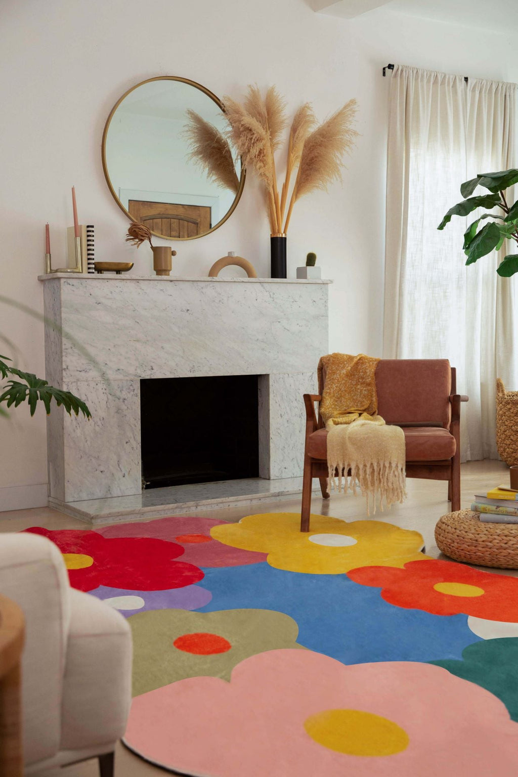 A cozy corner with warm sunlight and the funky flower rug partially shown under a rust-colored armchair.