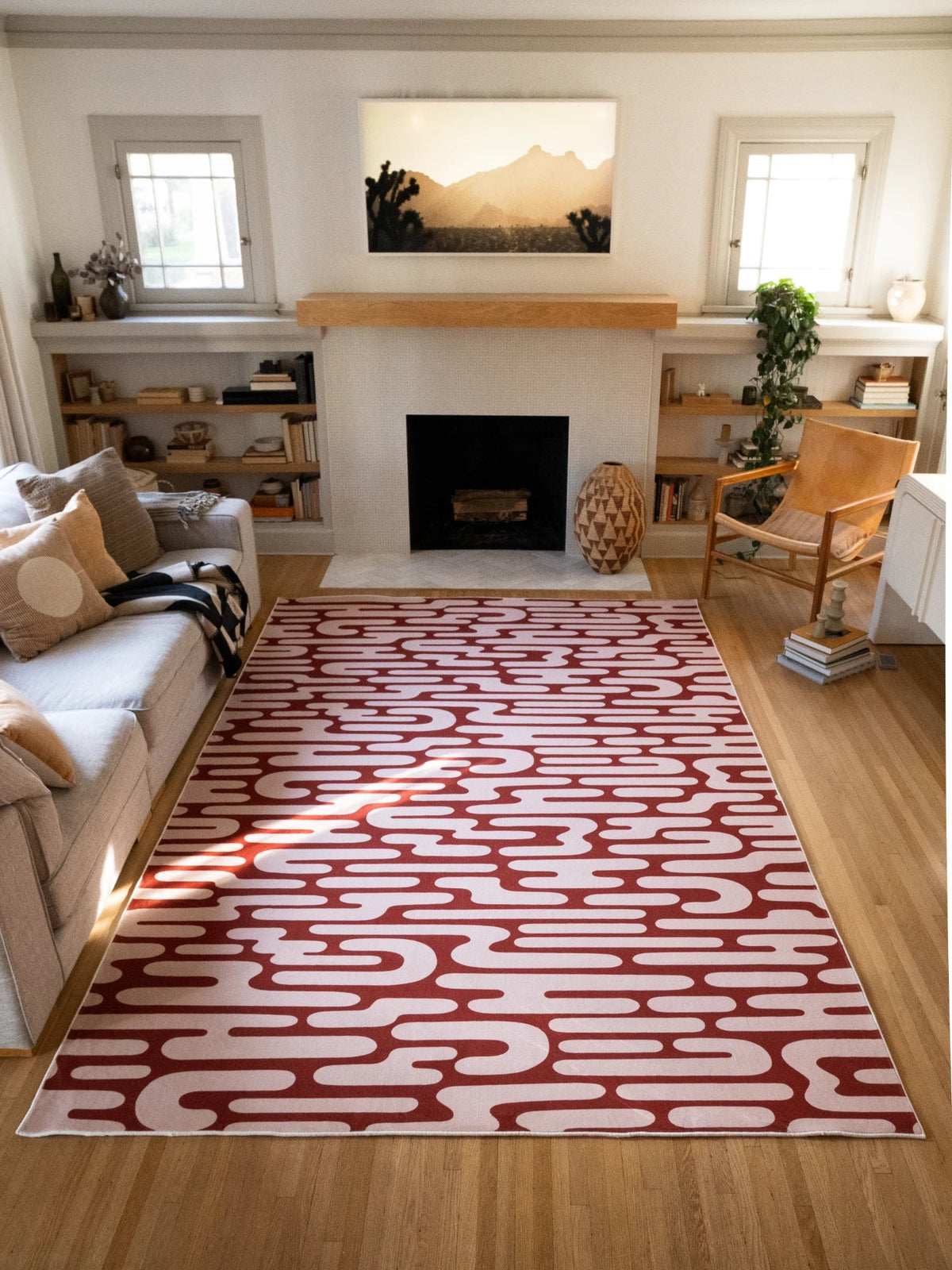 Brown Abstract Wavy Area Rug centered in a bright modern living room with open shelving and warm wood accents
