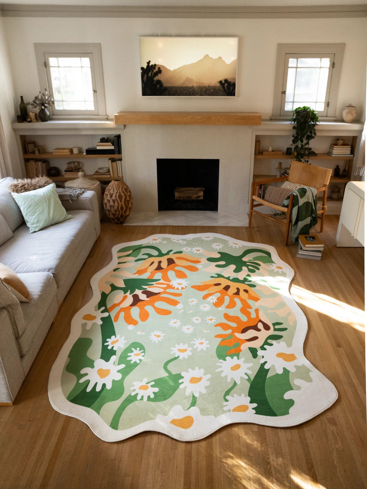 Soft green floral area rug spread between the sofa and fireplace on a light wood floor, with orange sunflower motifs