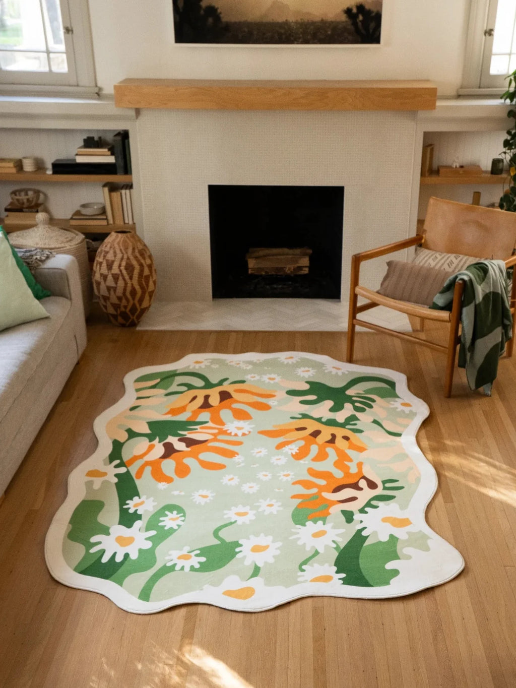 Irregular shaped sunflower floral rug in front of the fireplace, with a soft green ground and cream scalloped edge