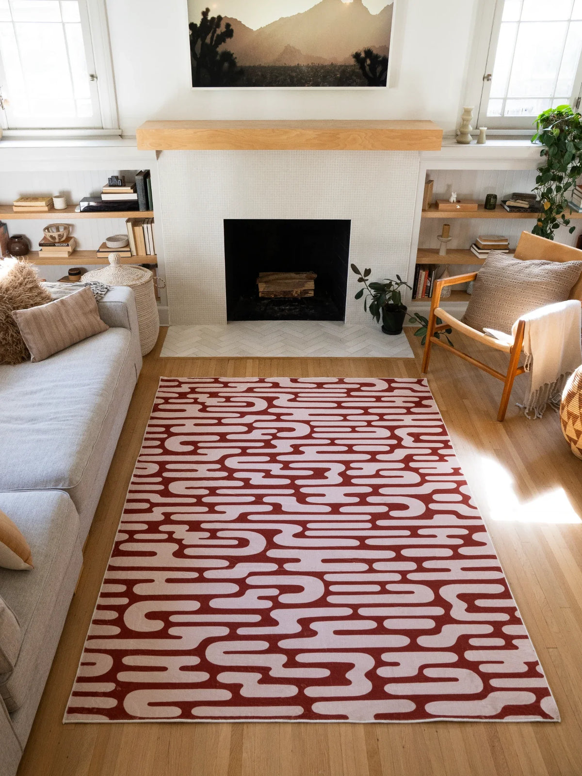Brown Abstract Wavy Area Rug in a sunlit modern living room with a fireplace, cream sofa, and wood chair