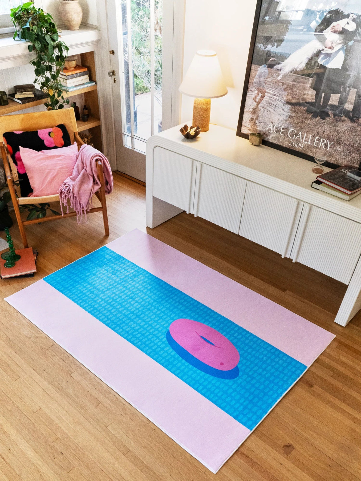 Pool inspired runner rug near a white media console in a bright living area, with a blue lane pattern and pink circle detail