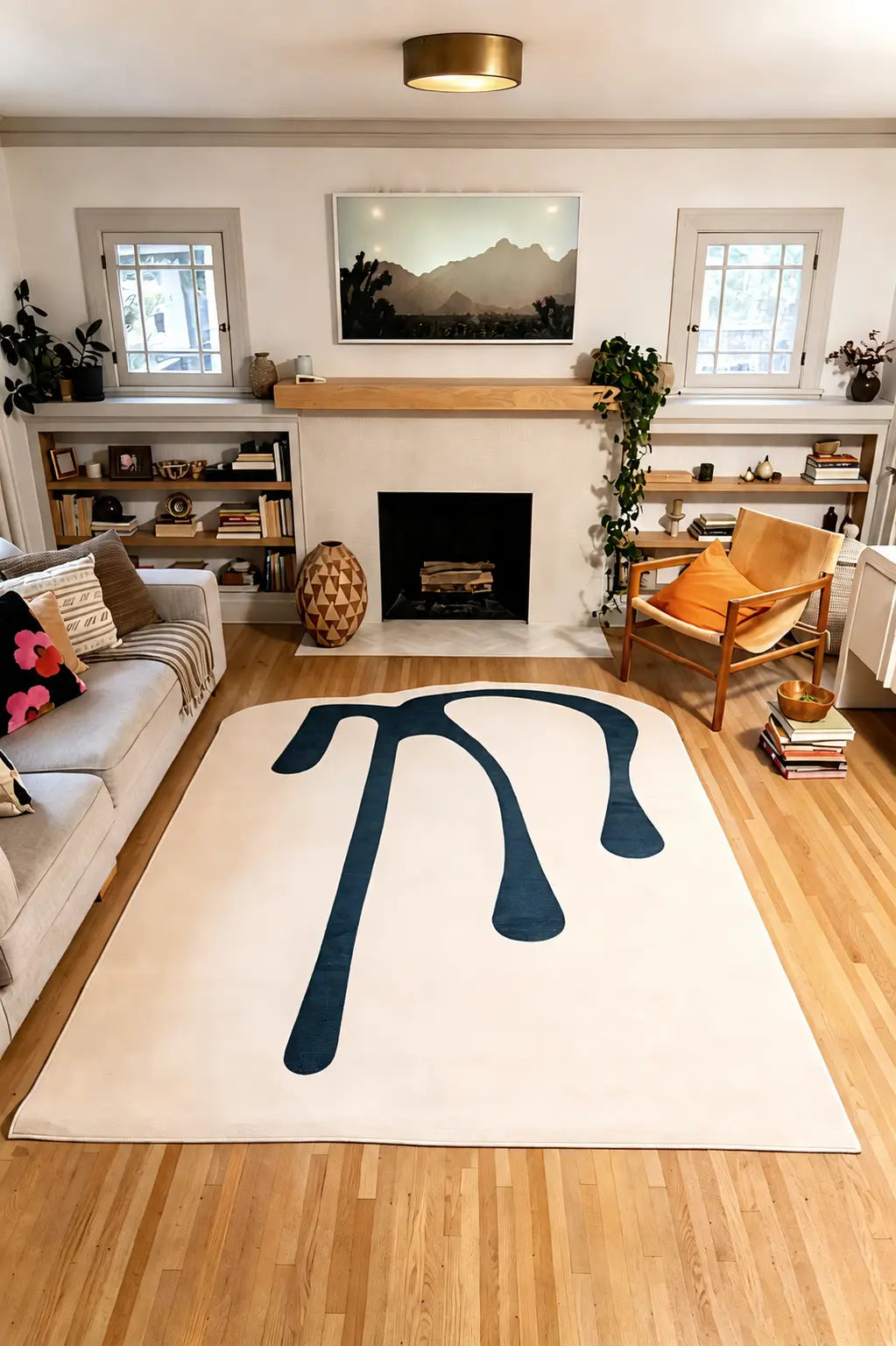 7' × 9' Beige Melting Abstract Art Rug by Ariana Berman between a gray sofa and wooden armchair in a living room.
