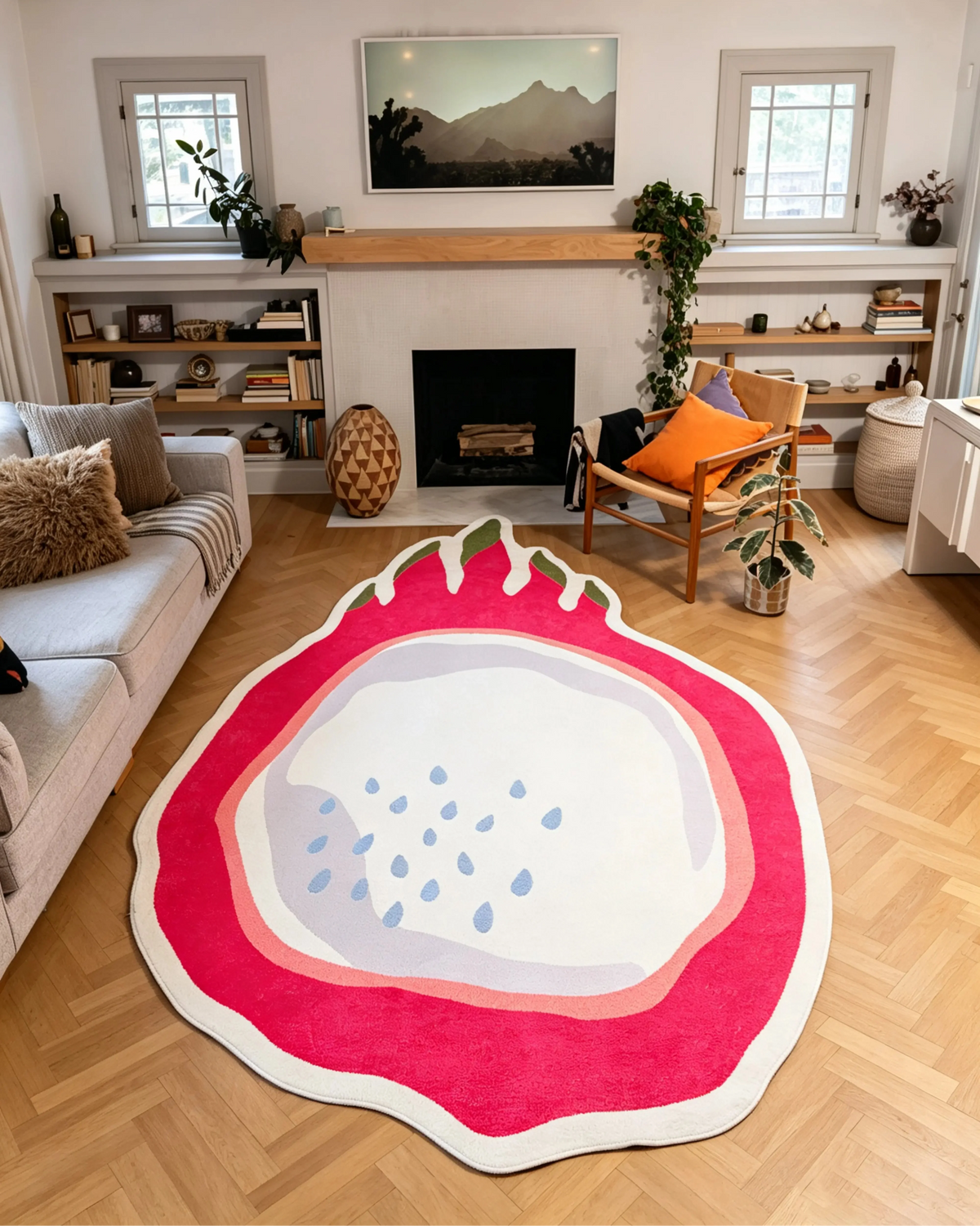 7' × 11' Red Irregular Dragon Fruit Rug by Maayan Alper-Swan with a hot pink rind, pale center, blue seeds, olive green tips, and white outline in front of a fireplace.