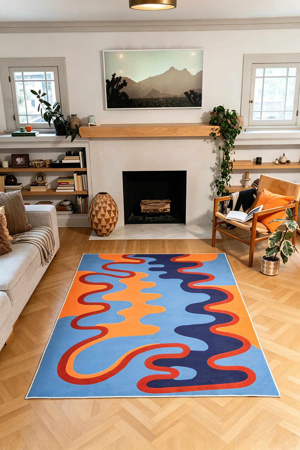 In the 5' × 7' size, orange and navy waves sit within a blue field while a red line winds toward the fireplace.