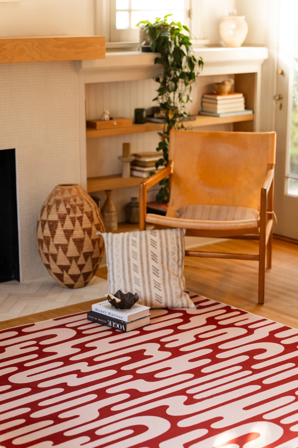 Brown Abstract Wavy Area Rug beside a wood chair and woven decor in a warm modern seating corner
