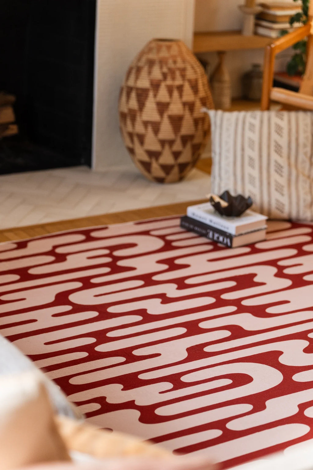 Brown Abstract Wavy Area Rug near stacked books and woven decor in a cozy modern living room