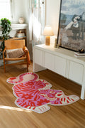 Pink tiger area rug beside a white media console and framed art in a creative living corner