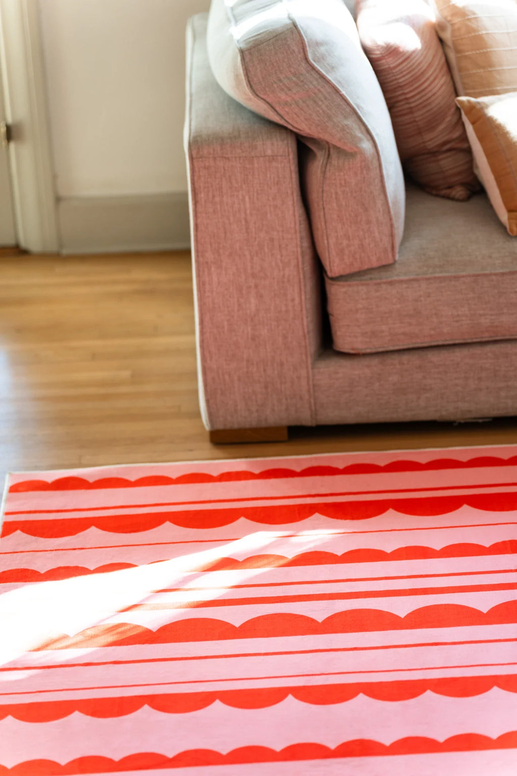 Orange and Pink Scalloped Striped Rug by Becca Franks