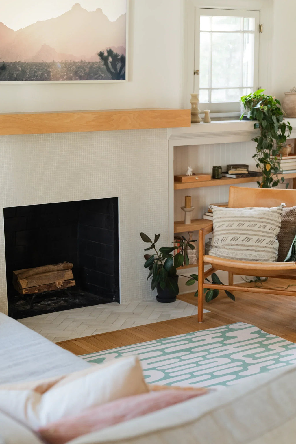 Green Abstract Wavy Area Rug in a relaxed modern living room beside a fireplace and wood framed chair