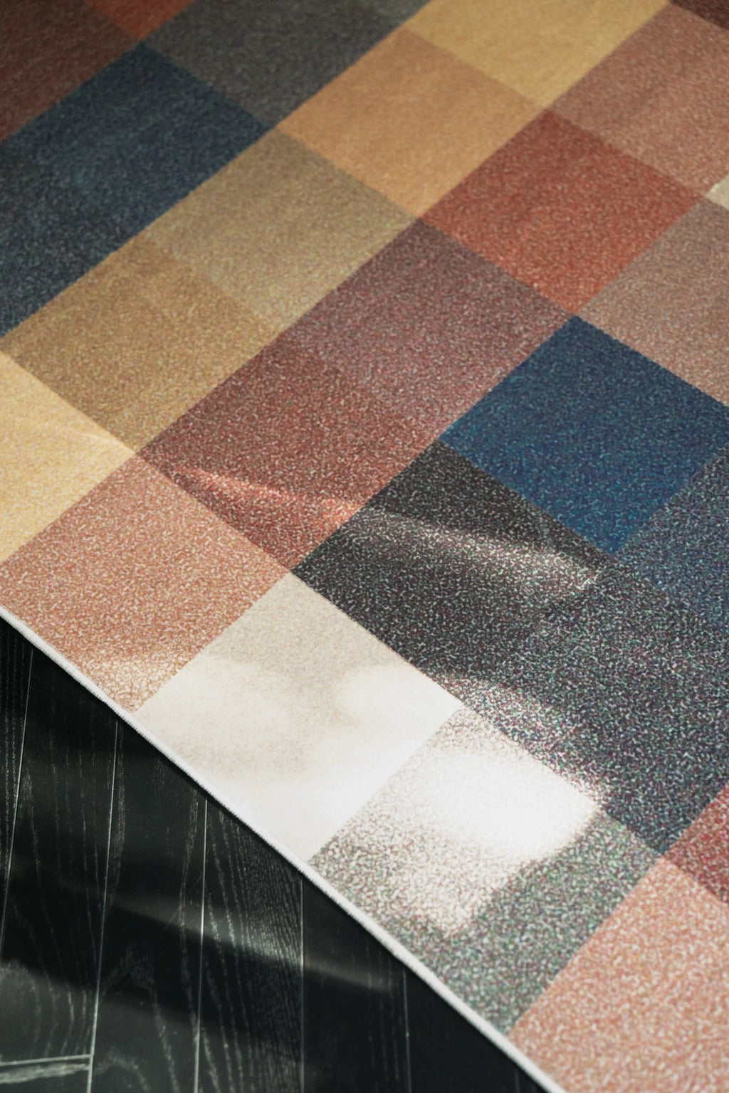 Corner close up of the Earthy Brown Vintage rug with blue and rust blocks and sunlight on the surface