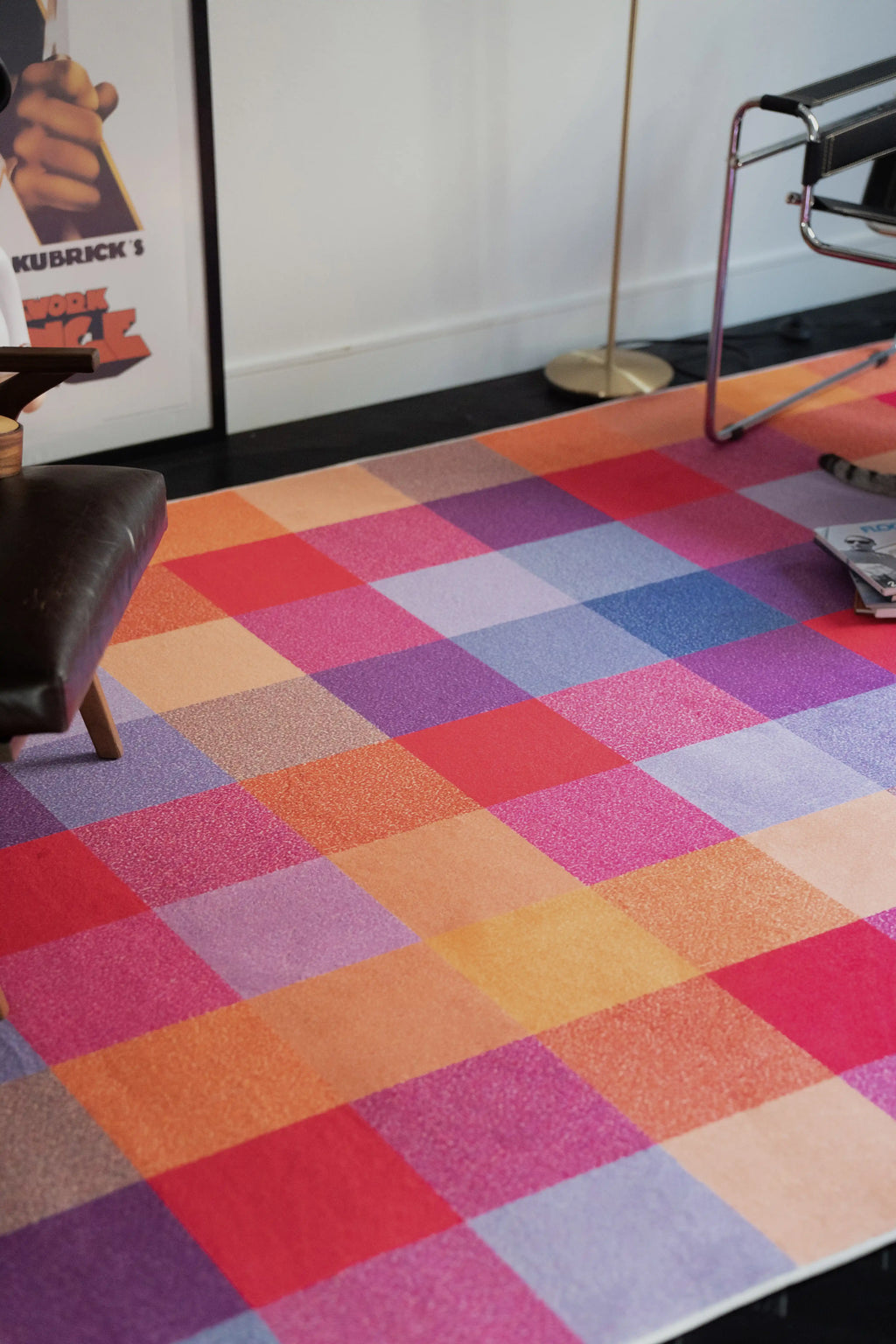 Juan Marquez checkered area rug placed beneath a desk chair in a modern home office