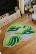 Irregular Botanical Leaves Rug by Maggie Stephenson in the living room, styled with rattan cabinet and boucle armchair.