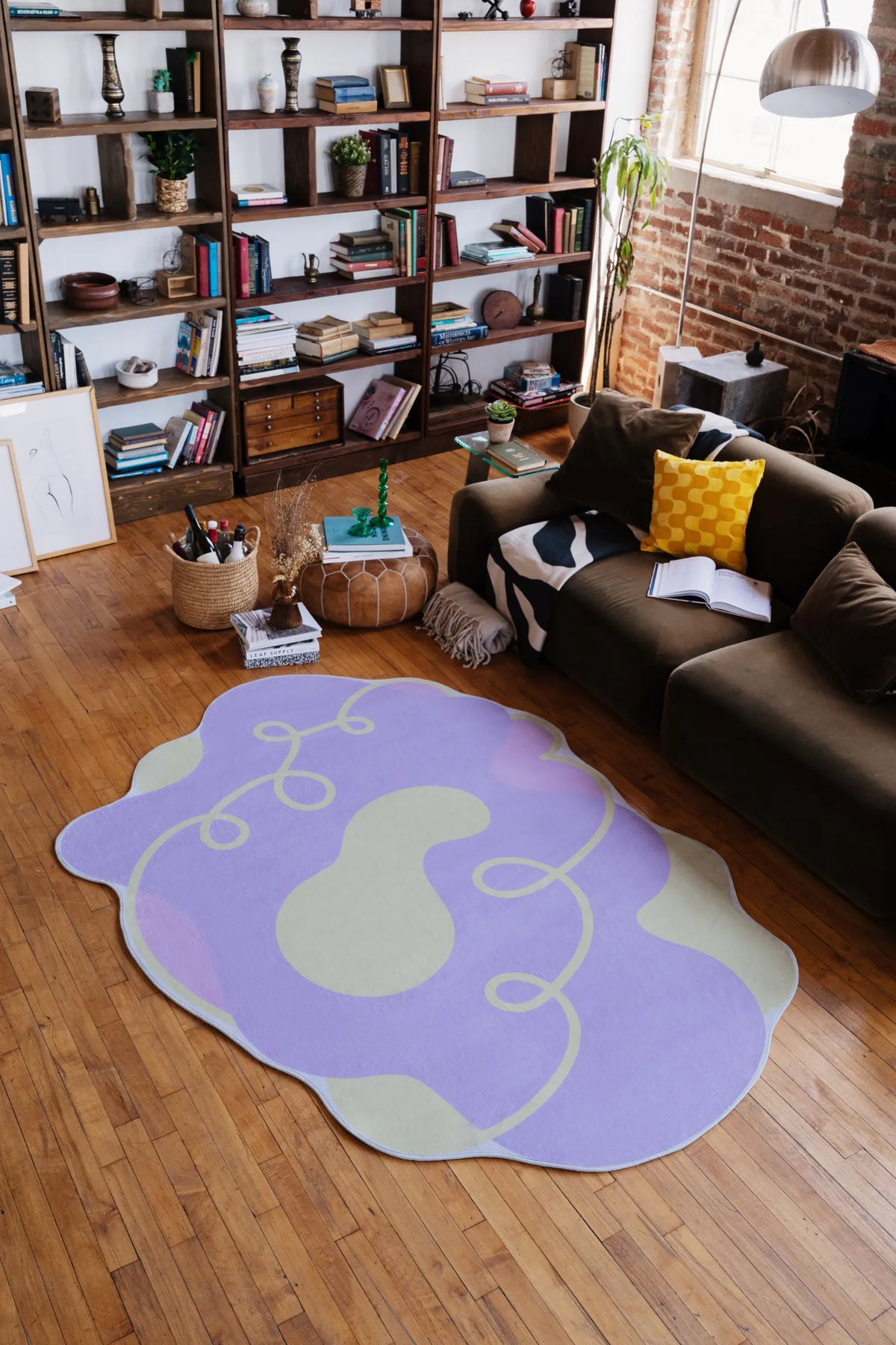 Lilac funky area rug with cream accents and looping yellow swirls, styled in a modern living room at 5'X7' with sofa and bookshelf.