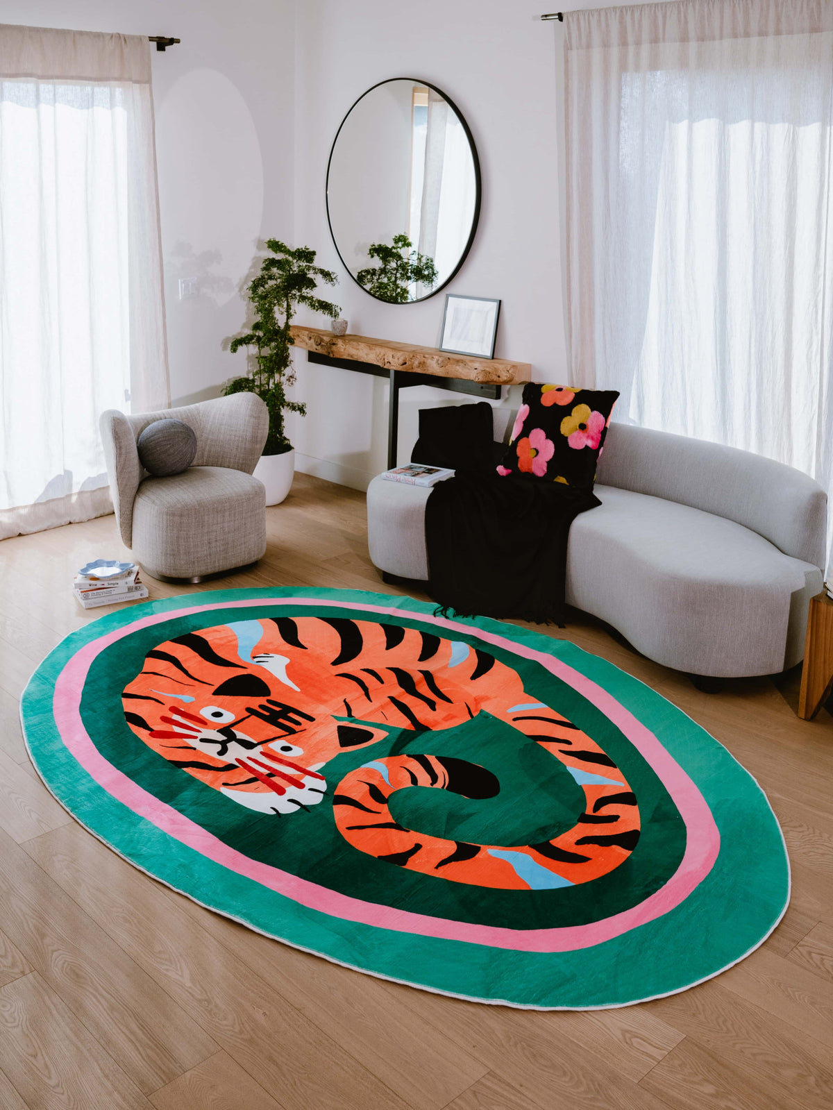 Vibrant tiger rug anchors the cozy living room setup, paired with soft seating and floral pillows for a playful touch.