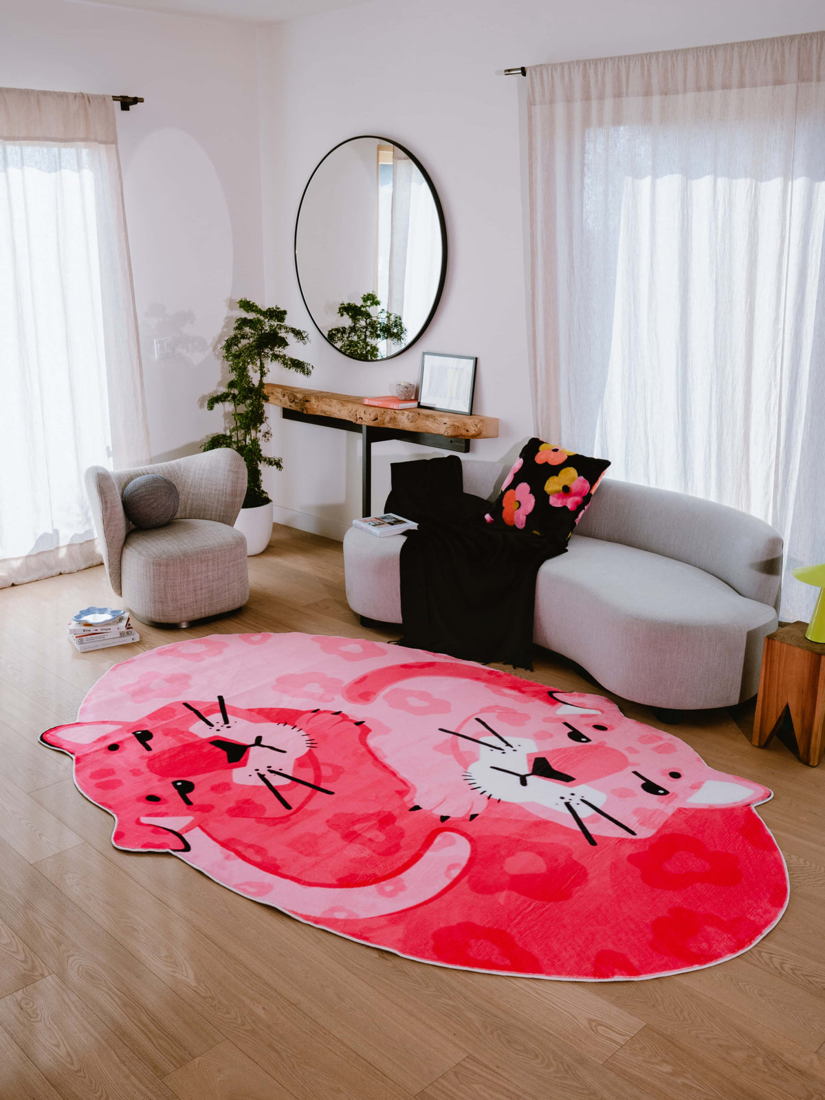 Cozy living room with Pink Panther Area Rug by Lu Yang, surrounded by soft furnishings and natural light.