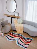 Irregular shaped multicolor contour runner rug in bright living room, styled with curved sofa and rustic wood console table.