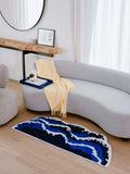 Blue wavy runner rug adds a pop of texture and calm beside bed, enhancing the bedroom’s cozy layered decor.