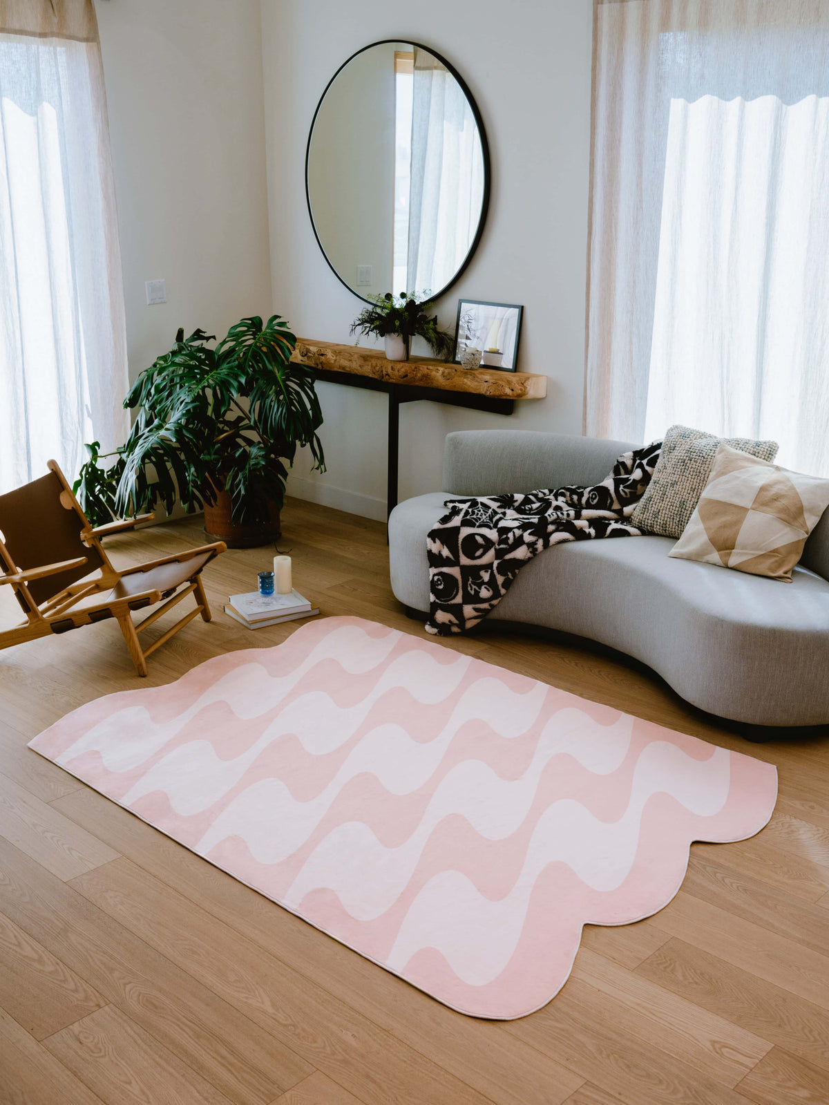 Beige version of pastel irregular shaped wavy rug placed in a bright, modern living room.