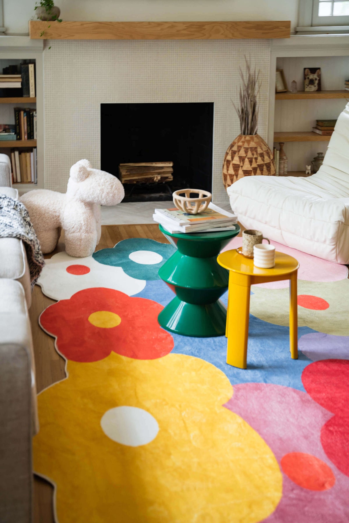 Colorful living room styled with the Funky Flowers Rug featuring bold floral shapes in red, yellow, green, and blue.