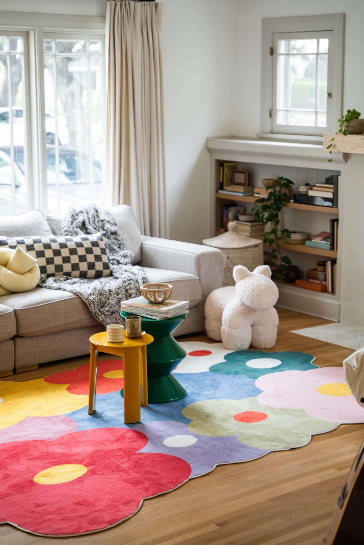 Playful interior showcasing the funky flower rug in full view, surrounded by soft neutral furniture and bright decor.