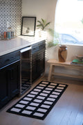 Grid Modern Design Black/White Runner placed in a bright, modern kitchen space beside dark cabinetry and a wood bench.