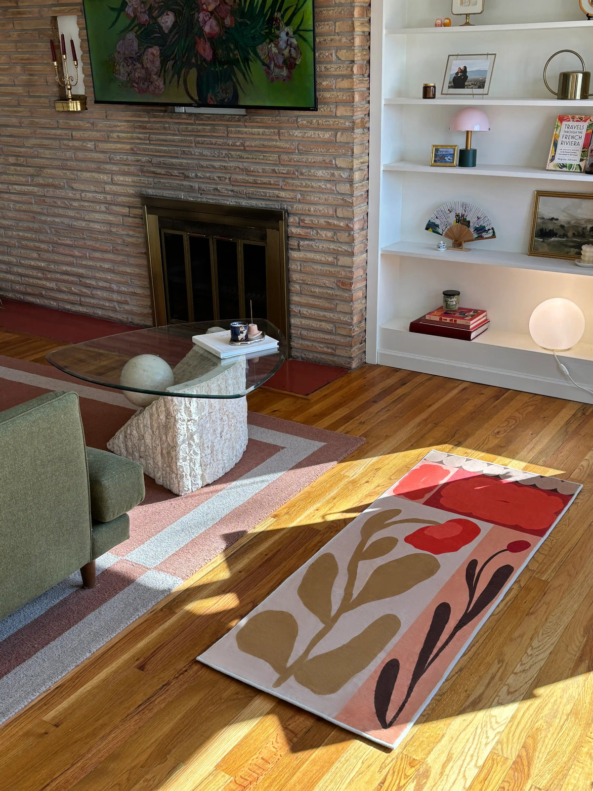 Patchwork floral runner rug in a sunlit living area near a fireplace, showing rust red blocks and beige leaf forms