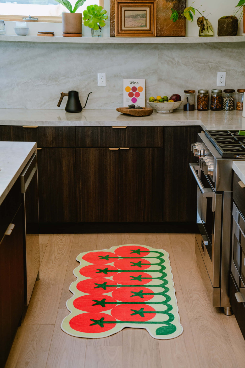 Tomato runner rug brightens the kitchen floor, placed in front of the stove with warm ambient lighting.