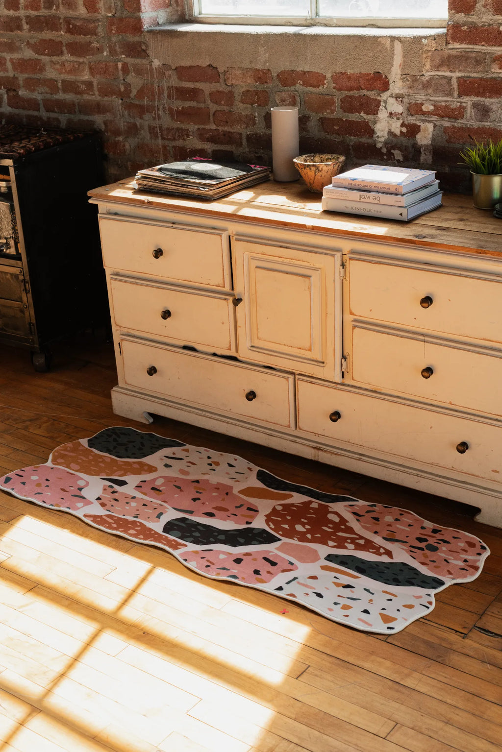 Mosaic Flow Abstract Runner rug placed on wood floor in front of a vintage dresser under natural light.