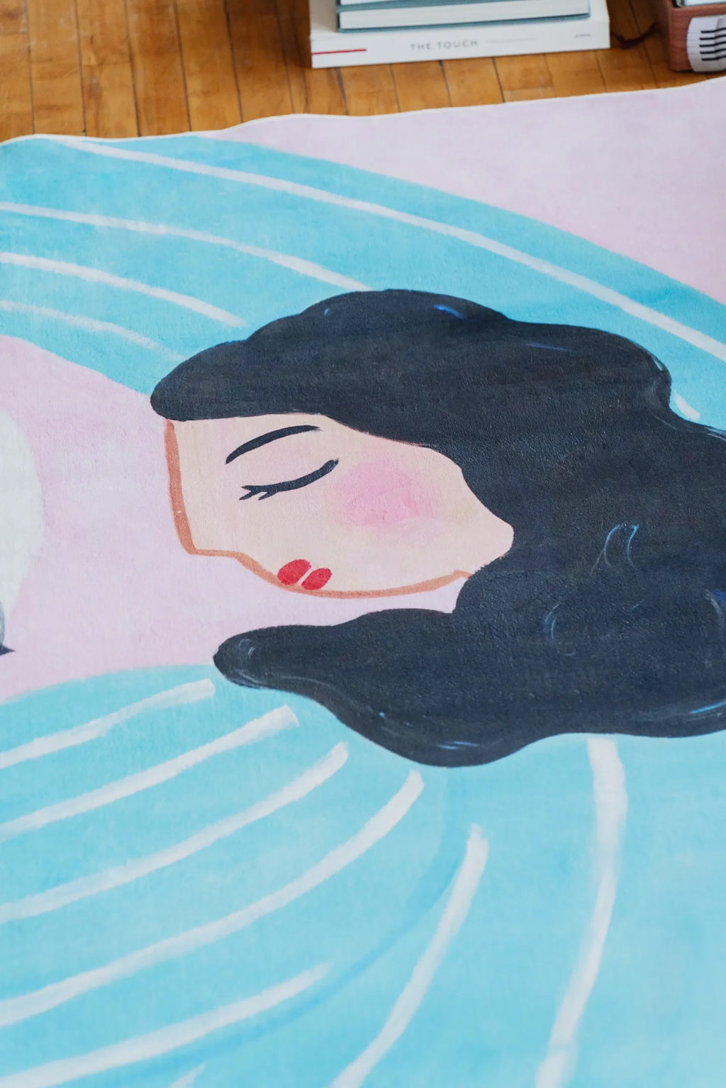 Funky Cat Lover Rug by Nimei in lilac and blue, featuring a close-up of the woman’s serene face detail on the design.