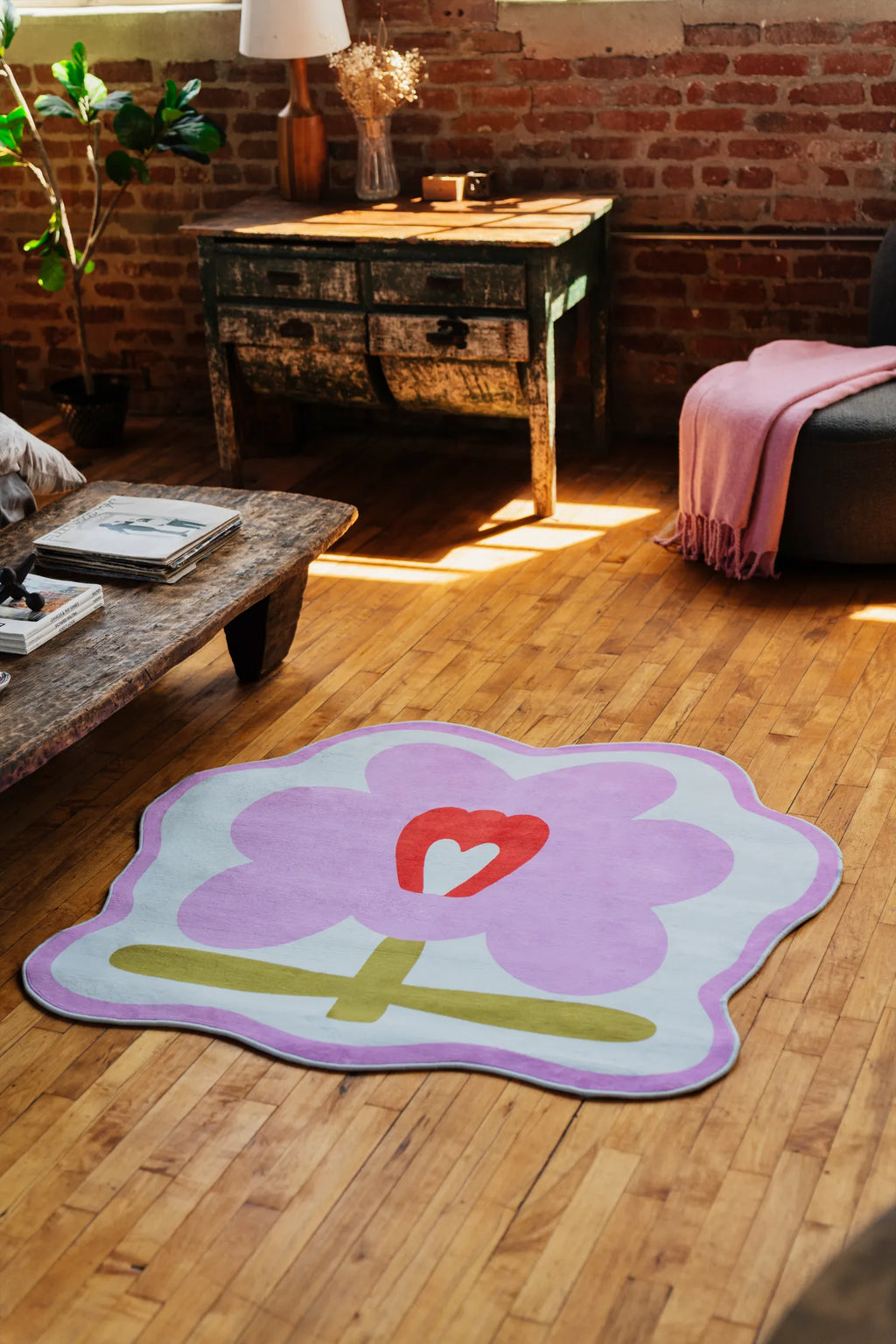 Pink flower rug set near rustic wooden bench with soft daylight, creating cozy modern area rug vibe.