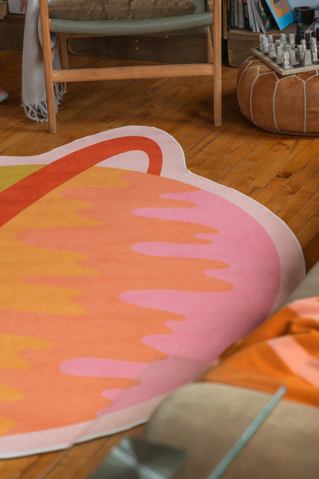 Close-up of colorful planet-shaped rug on wooden floor in cozy living room setting