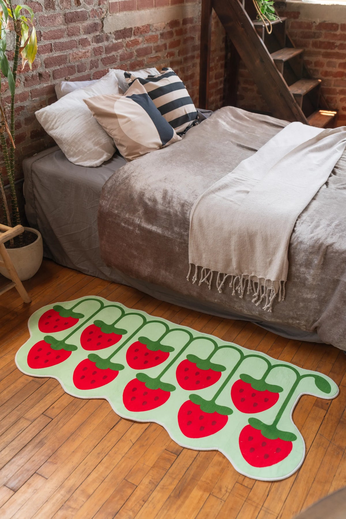 Cute fruit rug with strawberries in bright red and green next to velvet bed in cozy bedroom – aesthetic rug