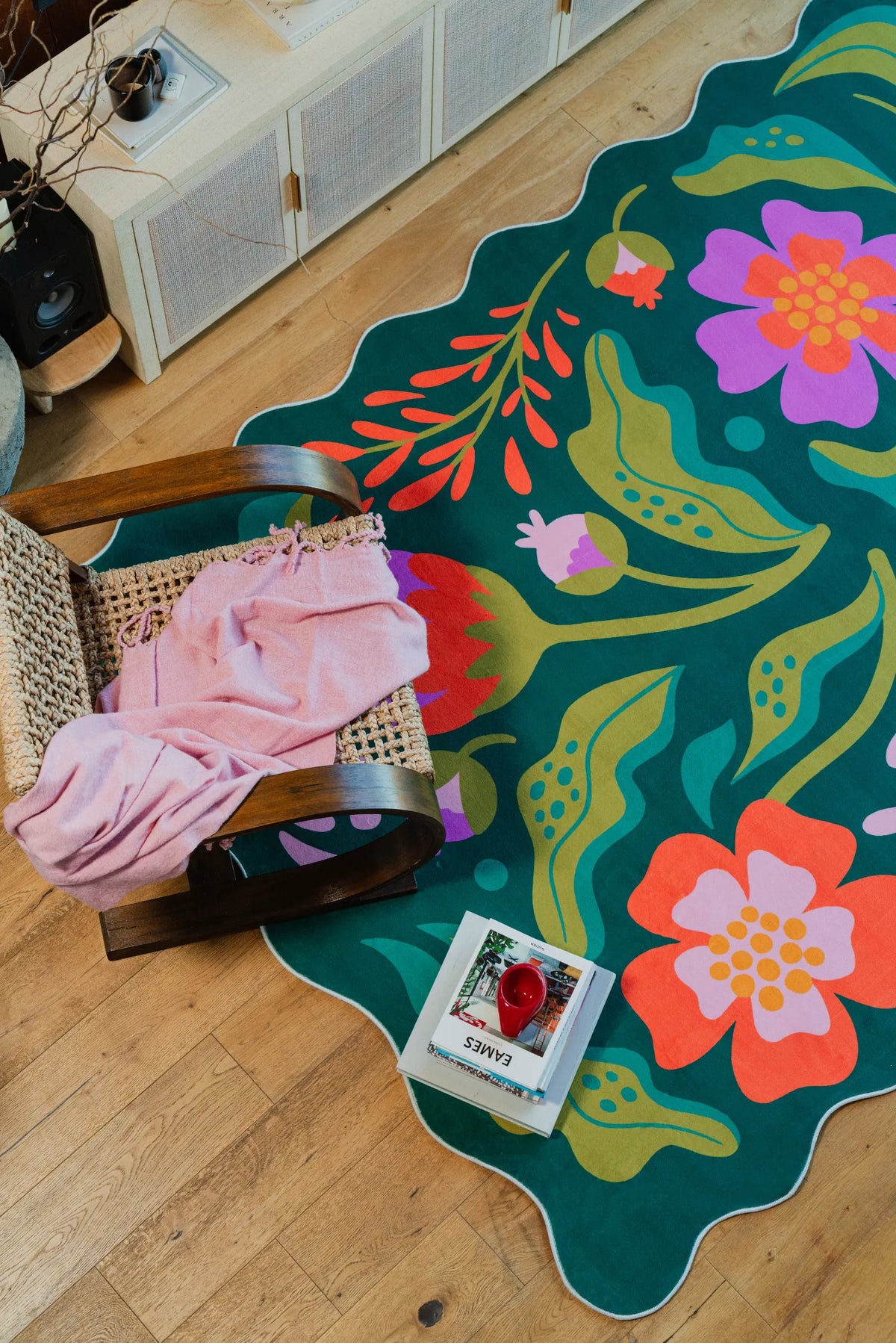 A cozy nook with a green rug featuring pink and purple floral accents from the latest Lany Space Designer Collection
