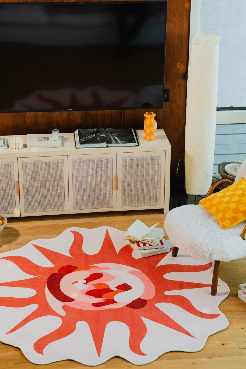 Solstice Earth Rug under a cozy armchair with a yellow pillow, creating a warm, inviting corner in the living room.